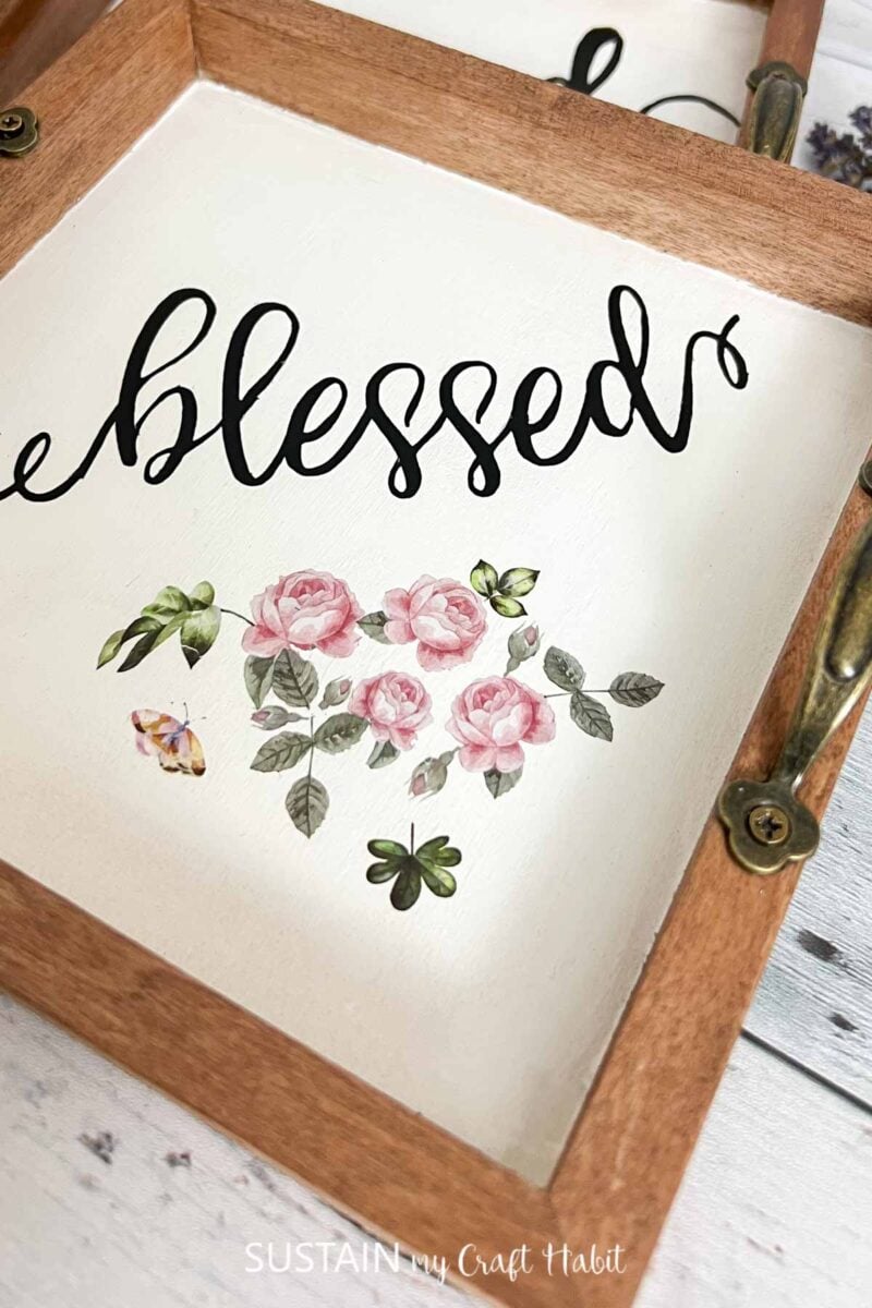Close up of flower transfer and blessed vinyl saying on the wood trinket tray.