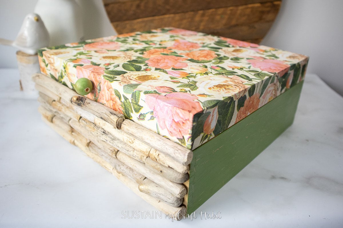 Decoupaged wood box decorated with flower napkins and driftwood.