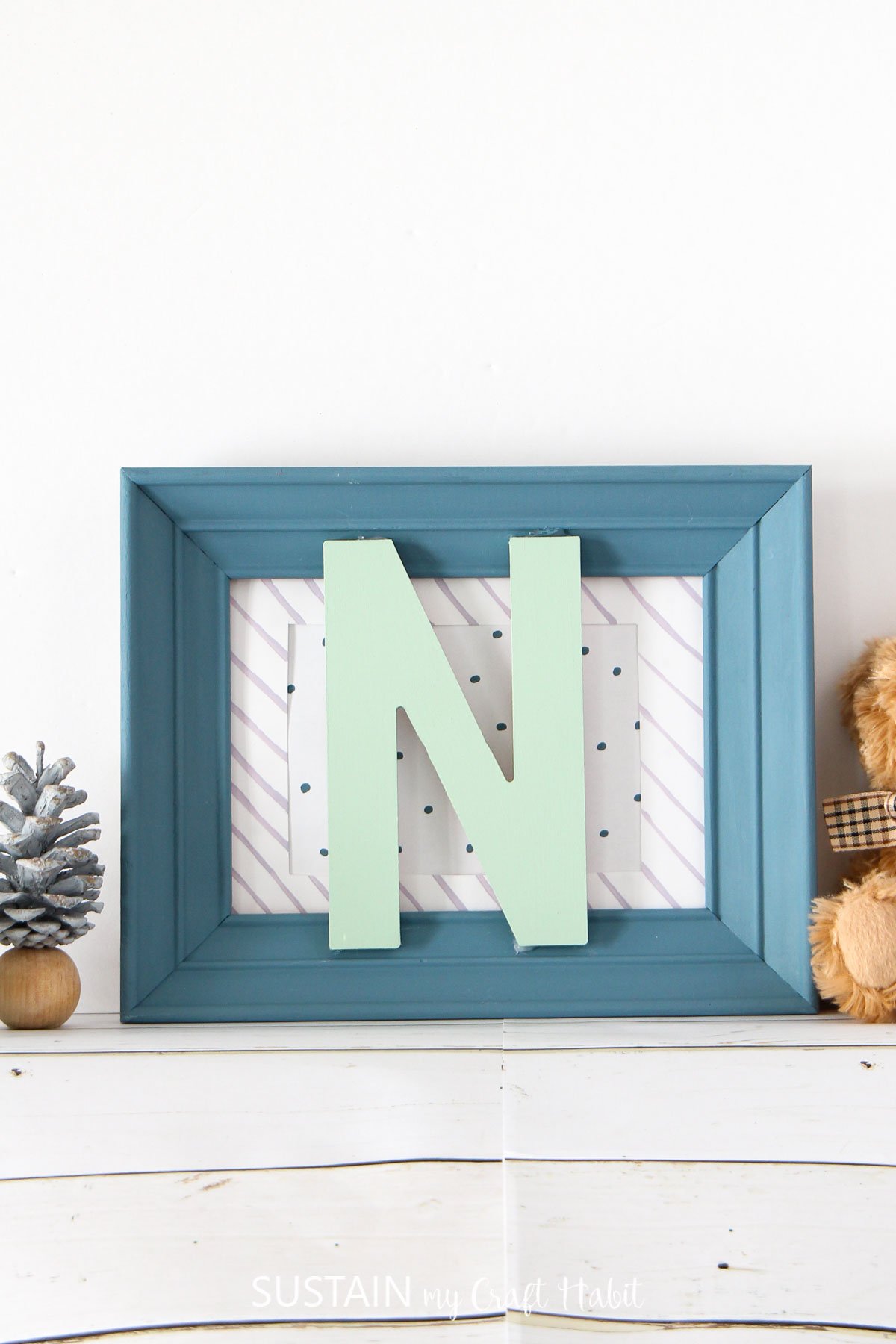 Nursery wall decor made from a vintage frame and monogram letter.