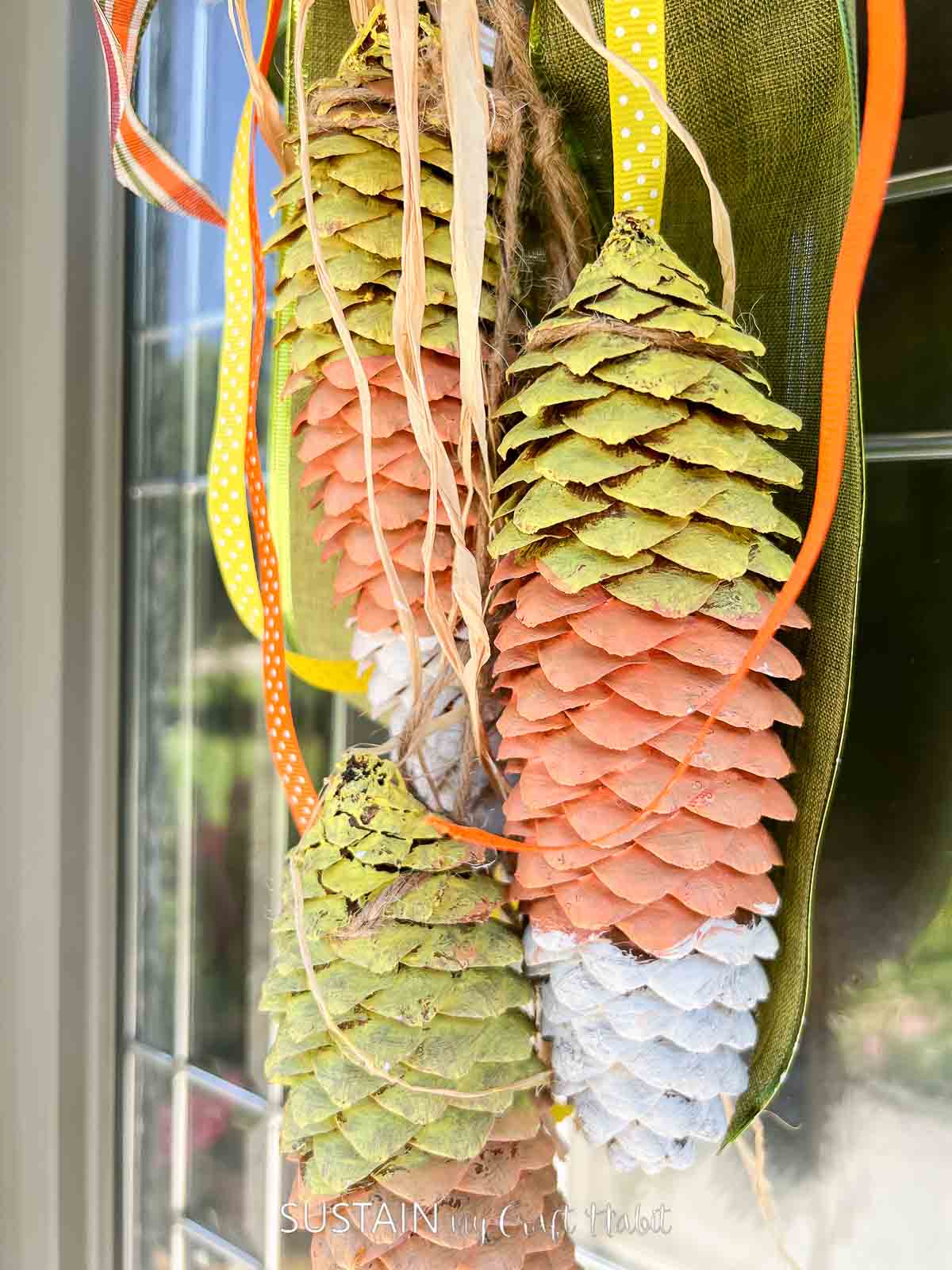 Close up of painted candy corn pine cones.
