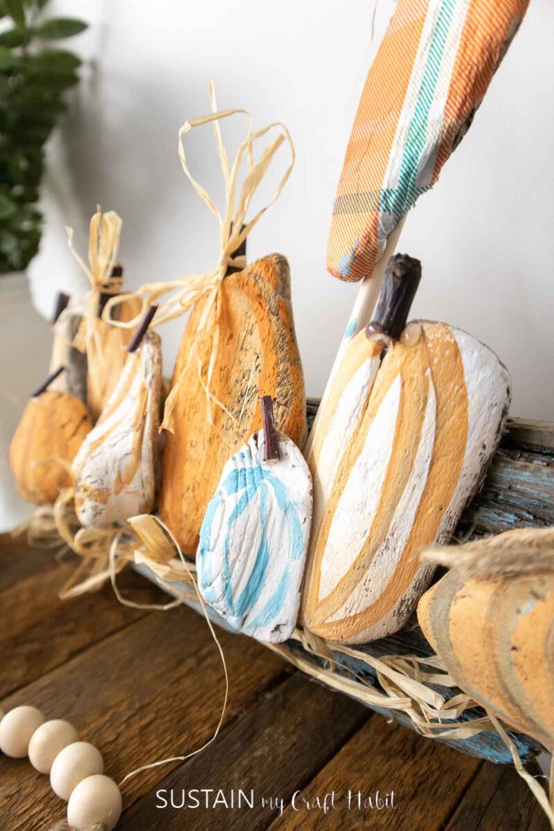 Close up of pumpkins made from painted driftwood.