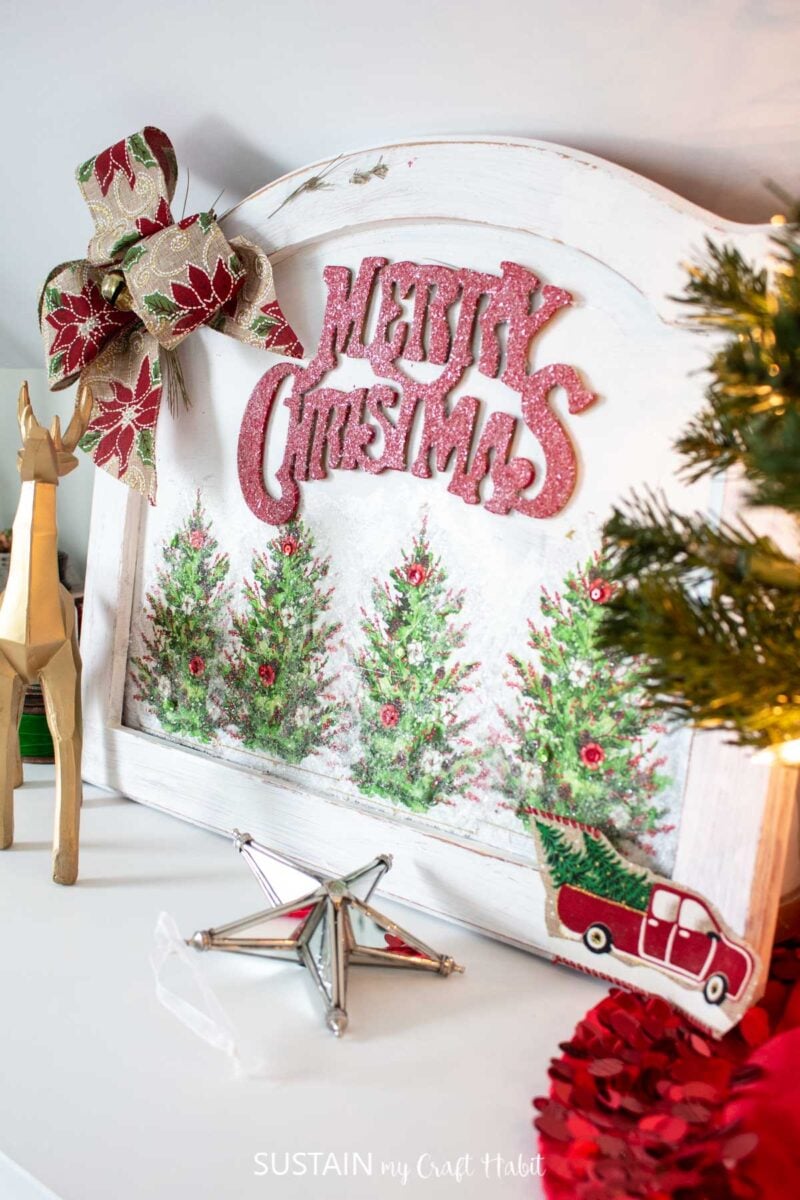 Christmas sign made with decoupage napkins and embellishments.