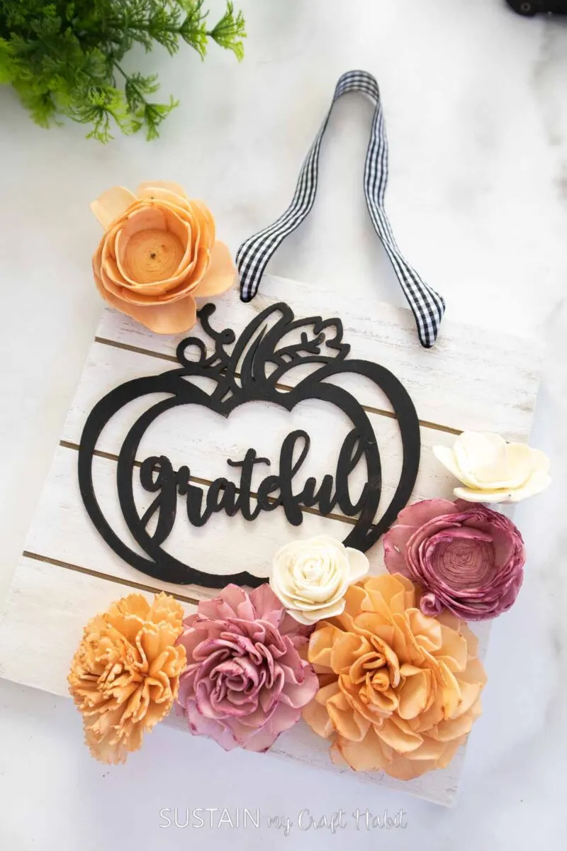 Fall sign decorated with a gather sign, ribbon and sola wood flowers.