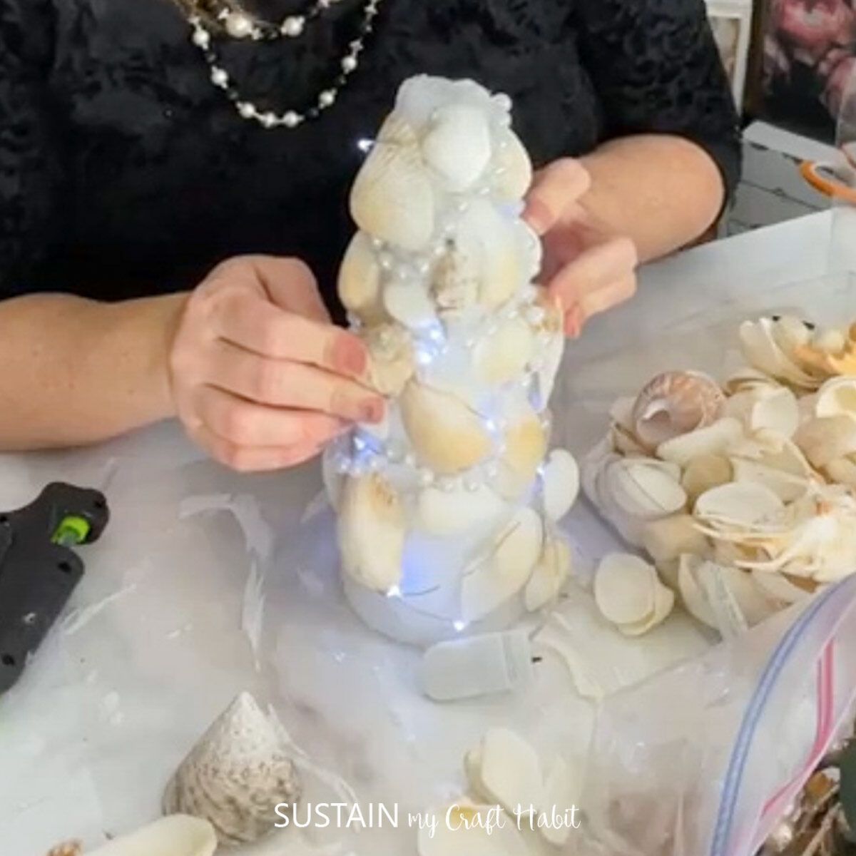 Gluing seashells onto a foam cone.