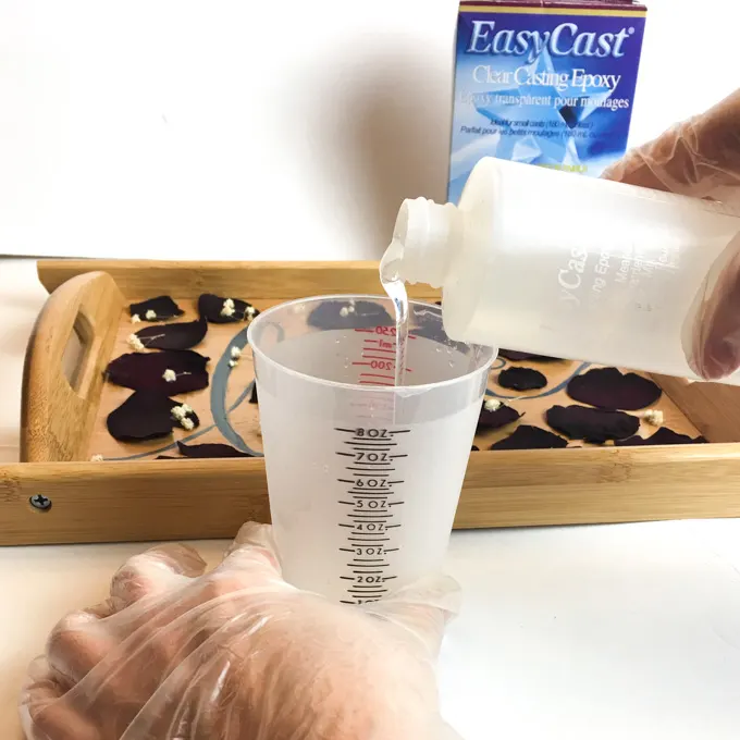 Pouring Resin into a measuring cup.