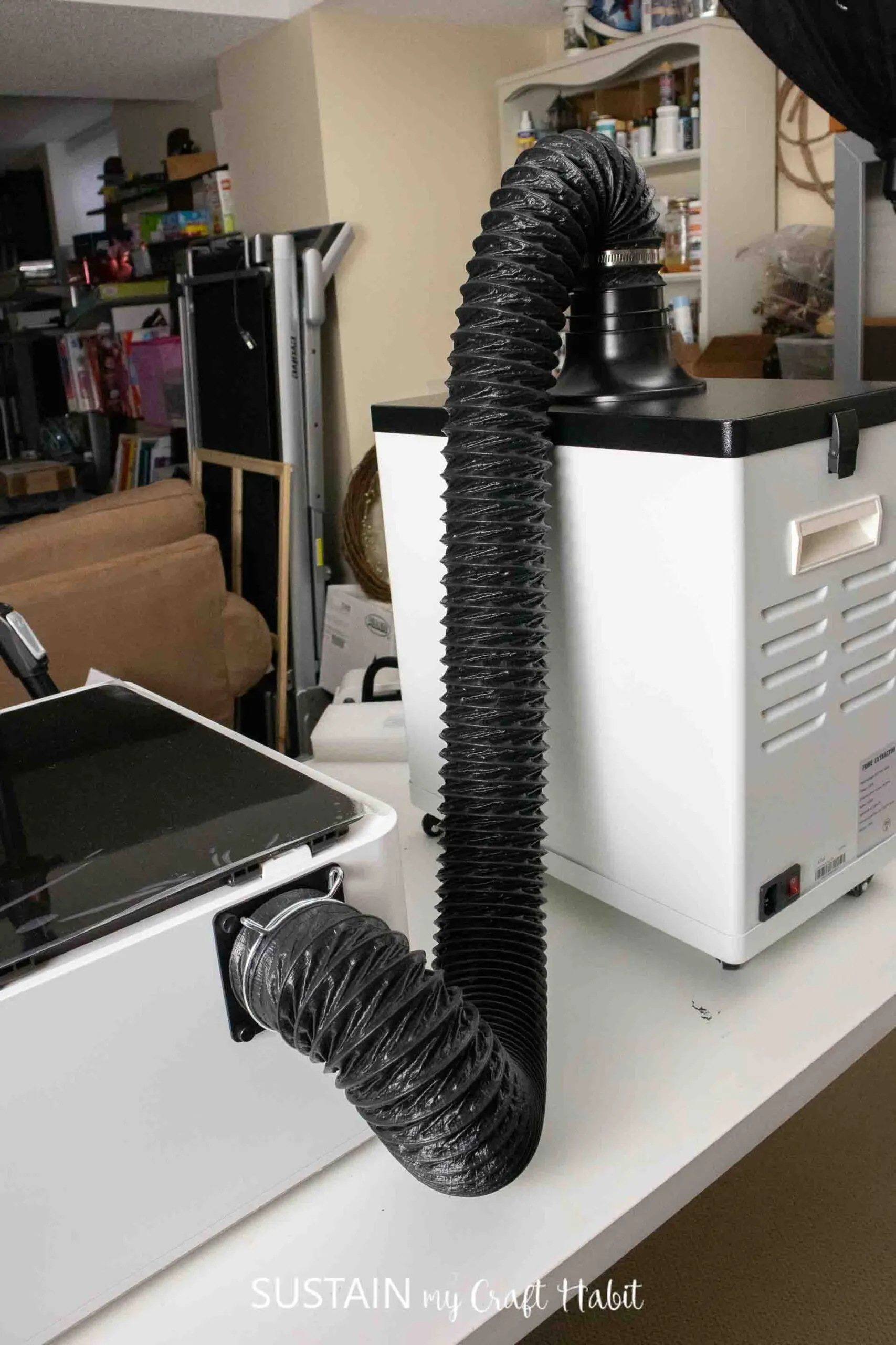 The XTool M1 machine connected to the XTool Smoke Purifier.