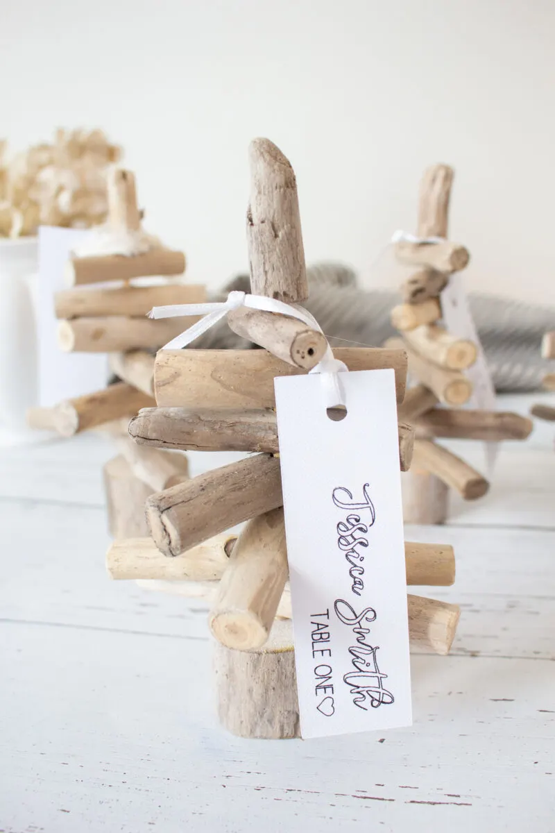 Mini driftwood trees with a thank you tag attached.
