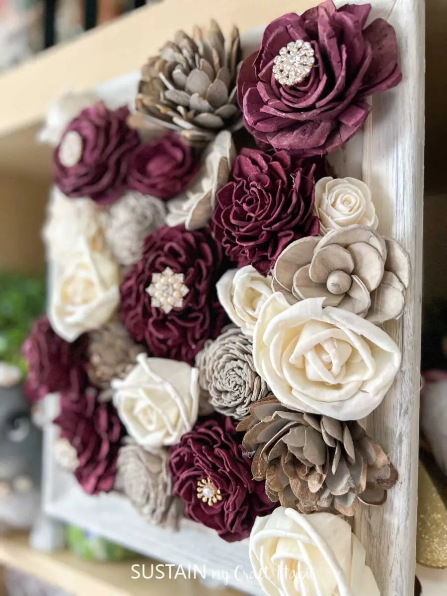 Close up of a framed wood flowers craft.