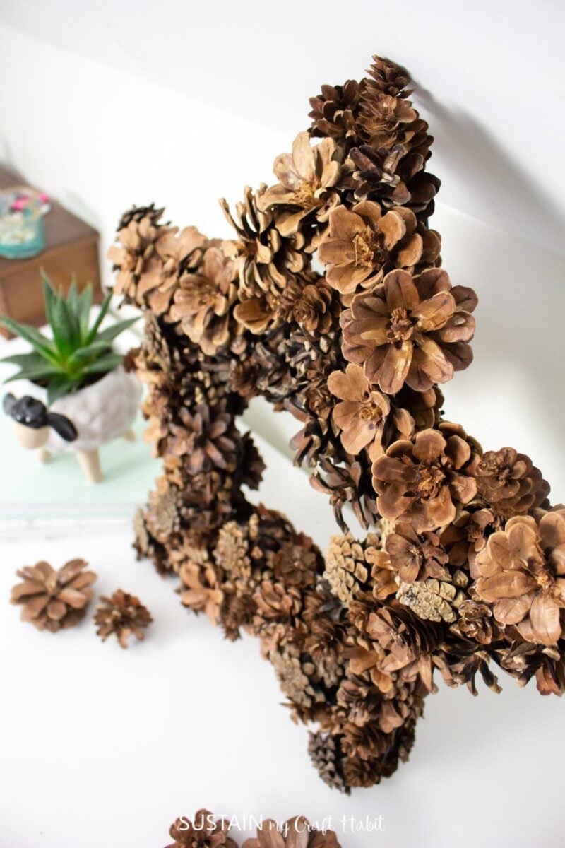 Overhead view of a pine cone star wreath.