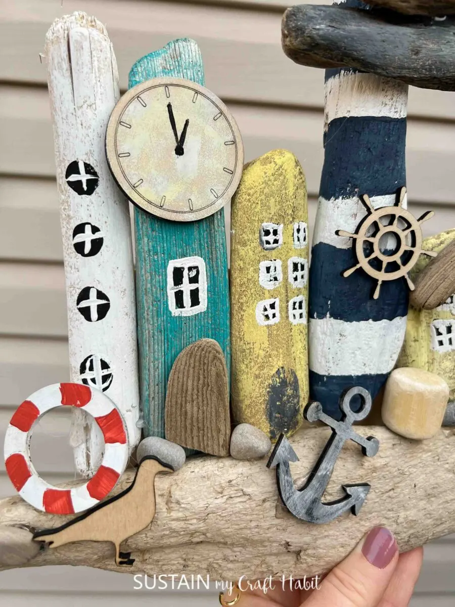 Beachy painted driftwood village with coastal embellishments.