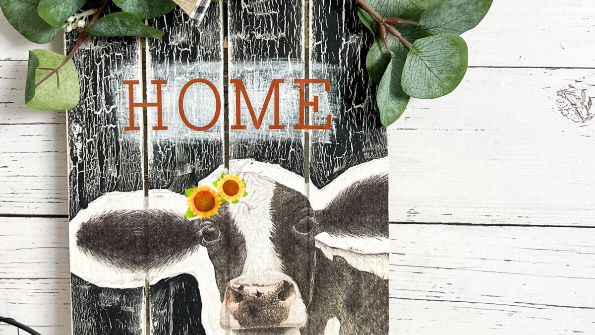 farmhouse cow sign with greenery