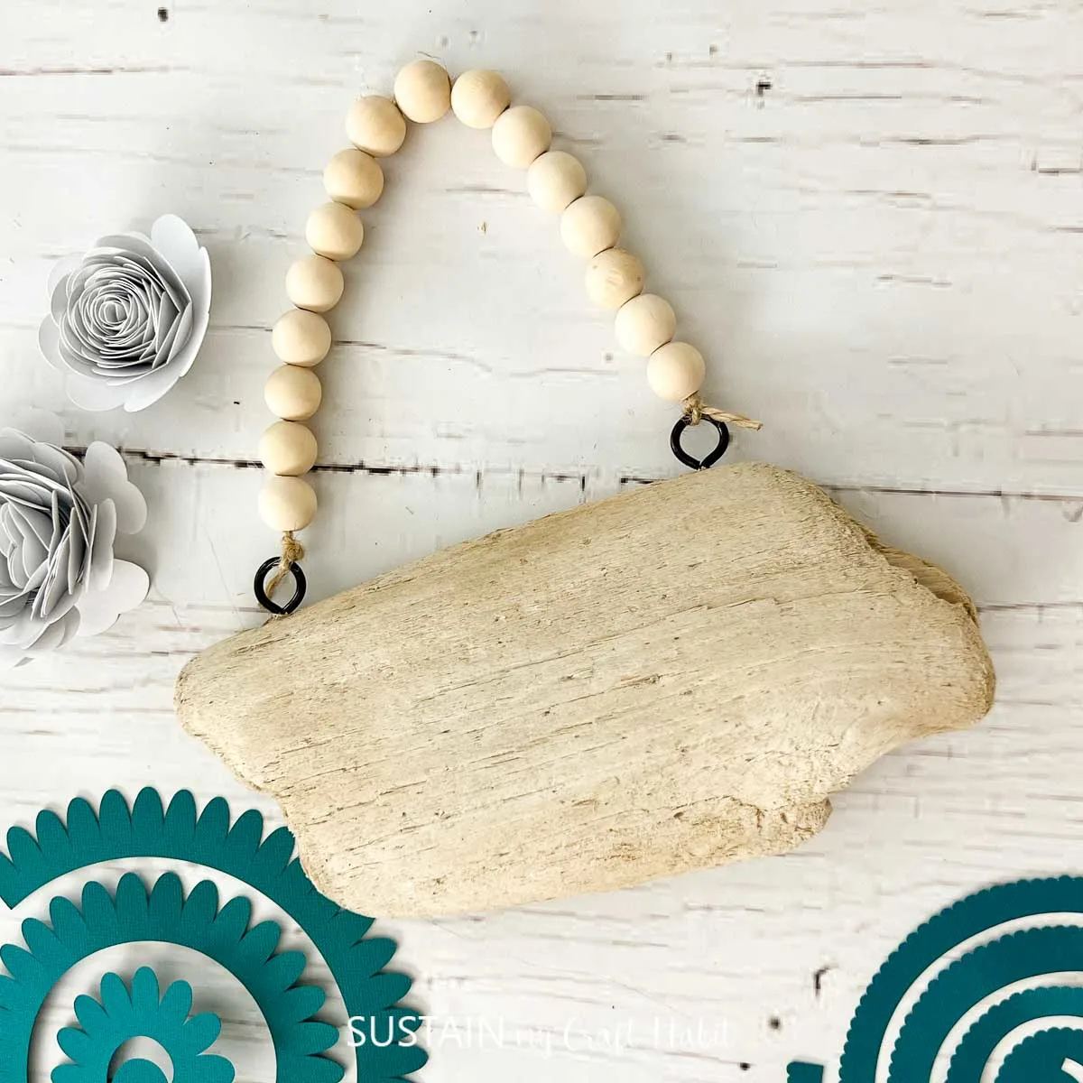 piece of driftwood with a wooden bead hanger