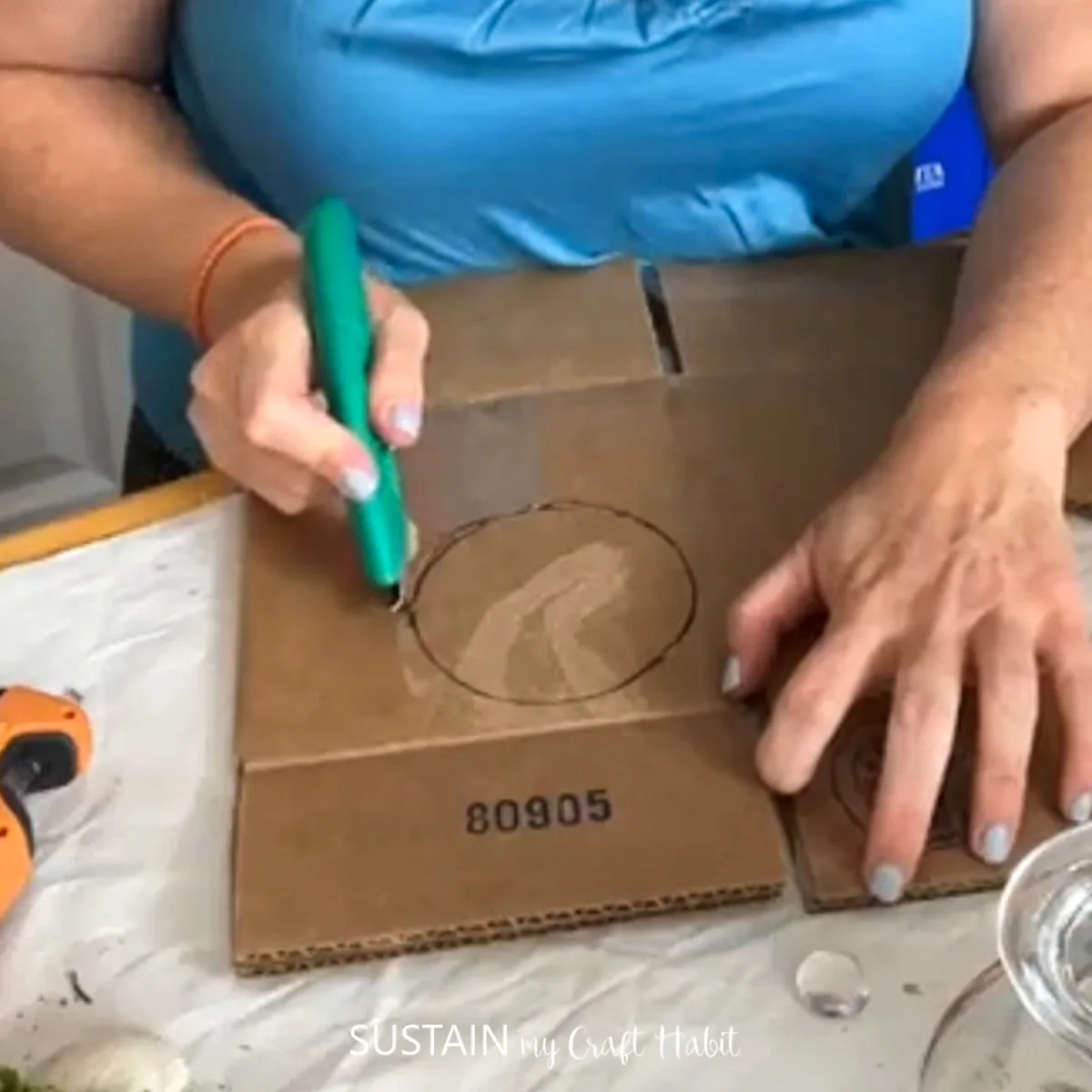 Cutting out a piece of cardboard.