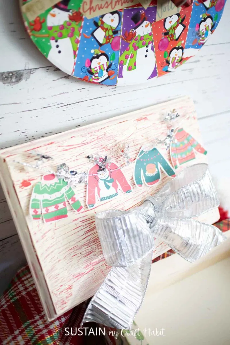 wooden box and wooden sign turned into ugly sweater crafts with ribbon, decoupage, bows and Christmas sweaters.