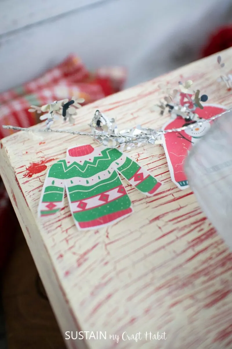 Close up of crackled wood box with ugly sweater printable. 