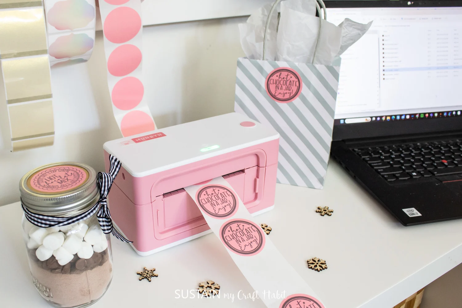 Pink Munbyn bluetooth thermal printer with round pink stickers being printed.