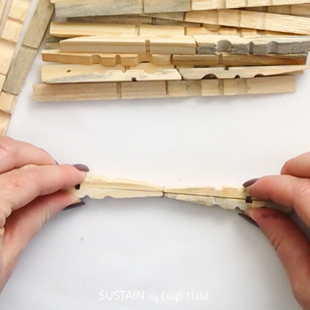 Gluing tips of clothespins together.
