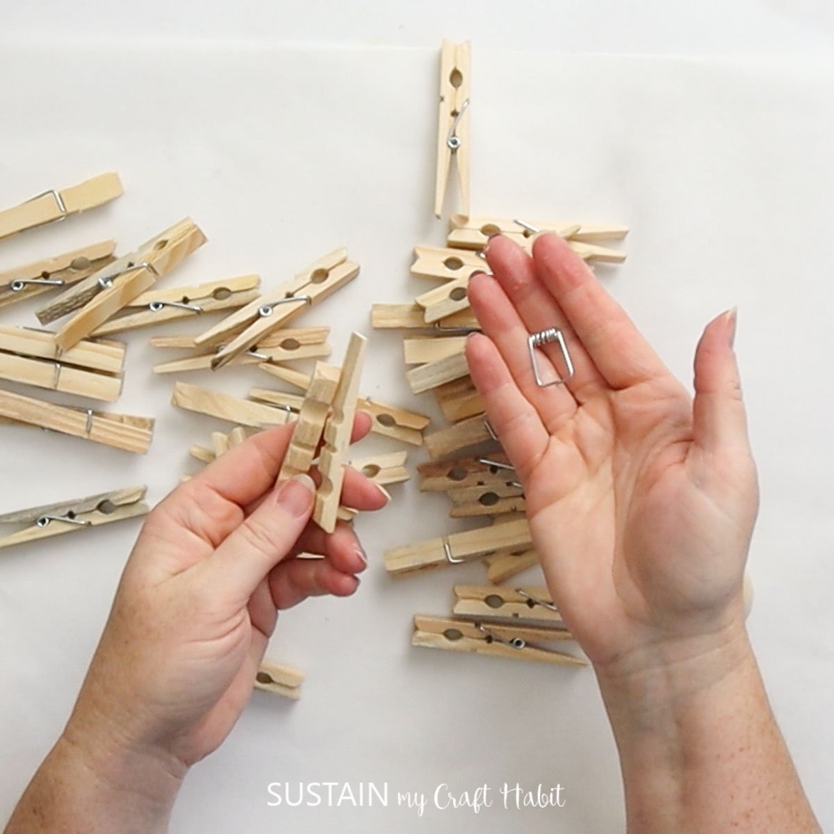 Removing metal springs from the clothespins.