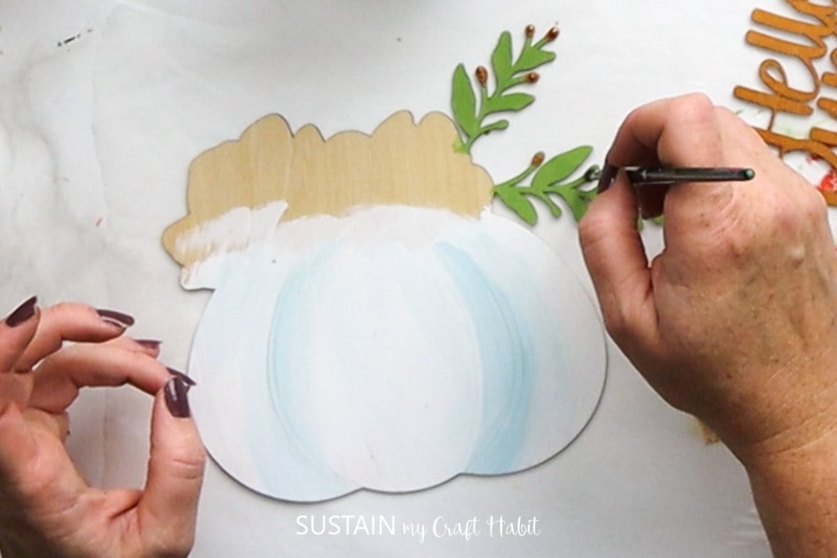 Painting buds onto the greenery.