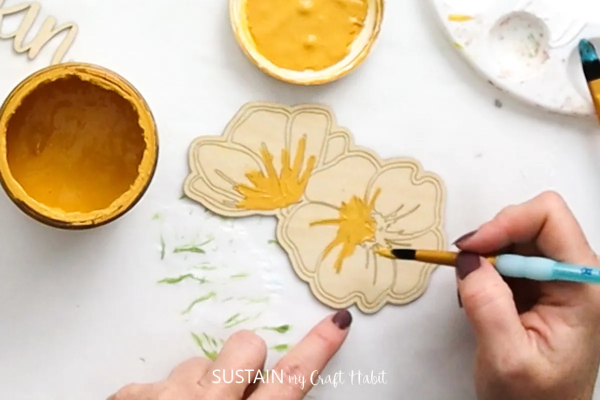 Painting the flower pistil yellow.