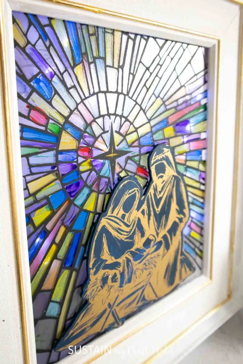 Stained glass Nativity scene in a picture frame.
