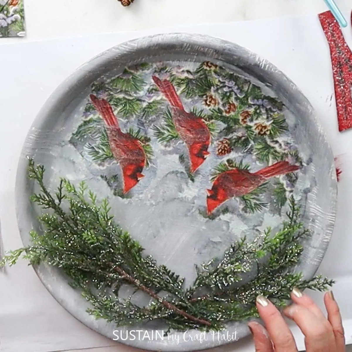 Attaching evergreen branches onto a tray.