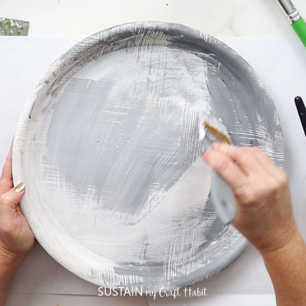 Painting over white paint with grey paint.