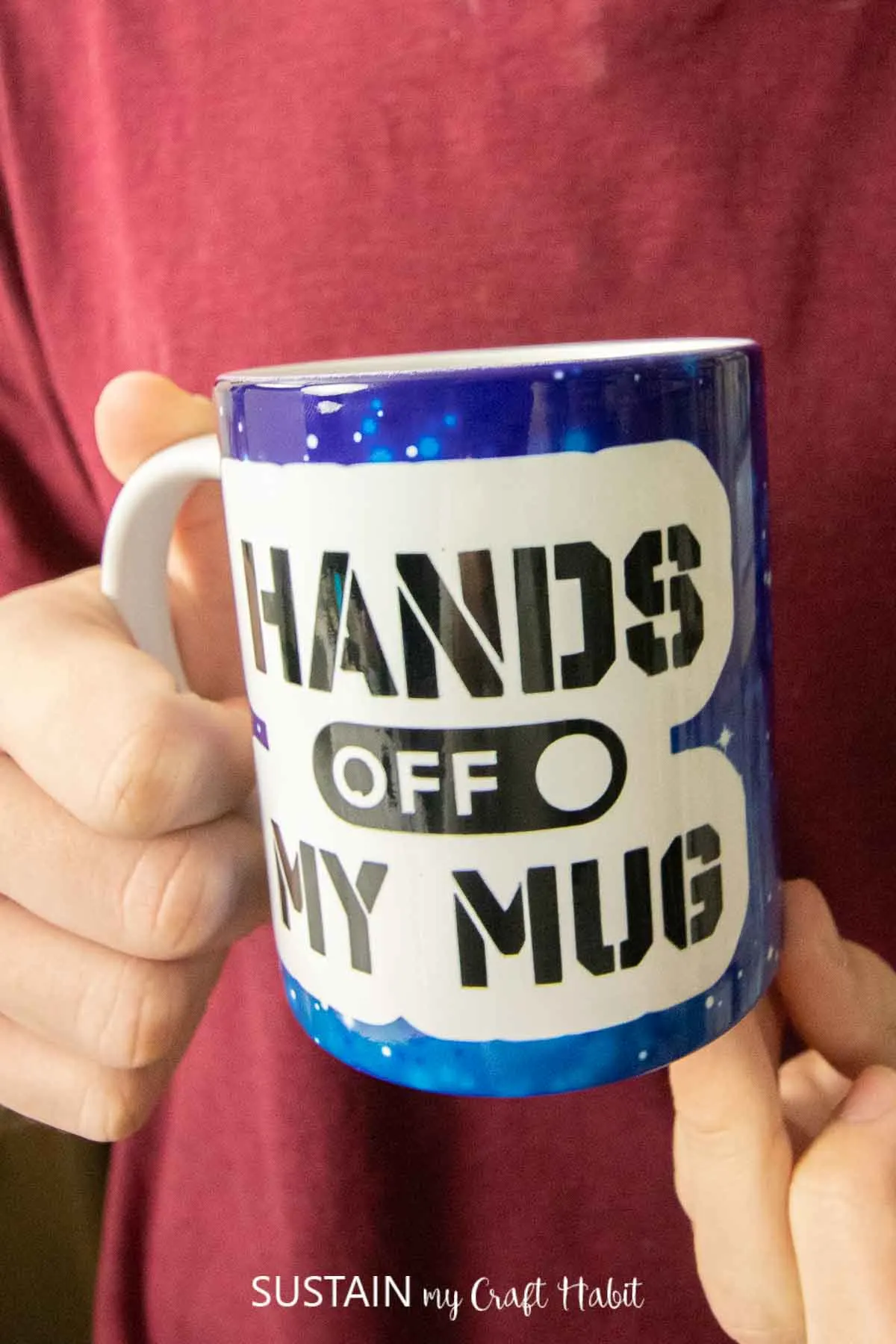 Close up image of coffee mug with the phrase "Hands off my mug" sublimated with Cricut Infusible Ink.