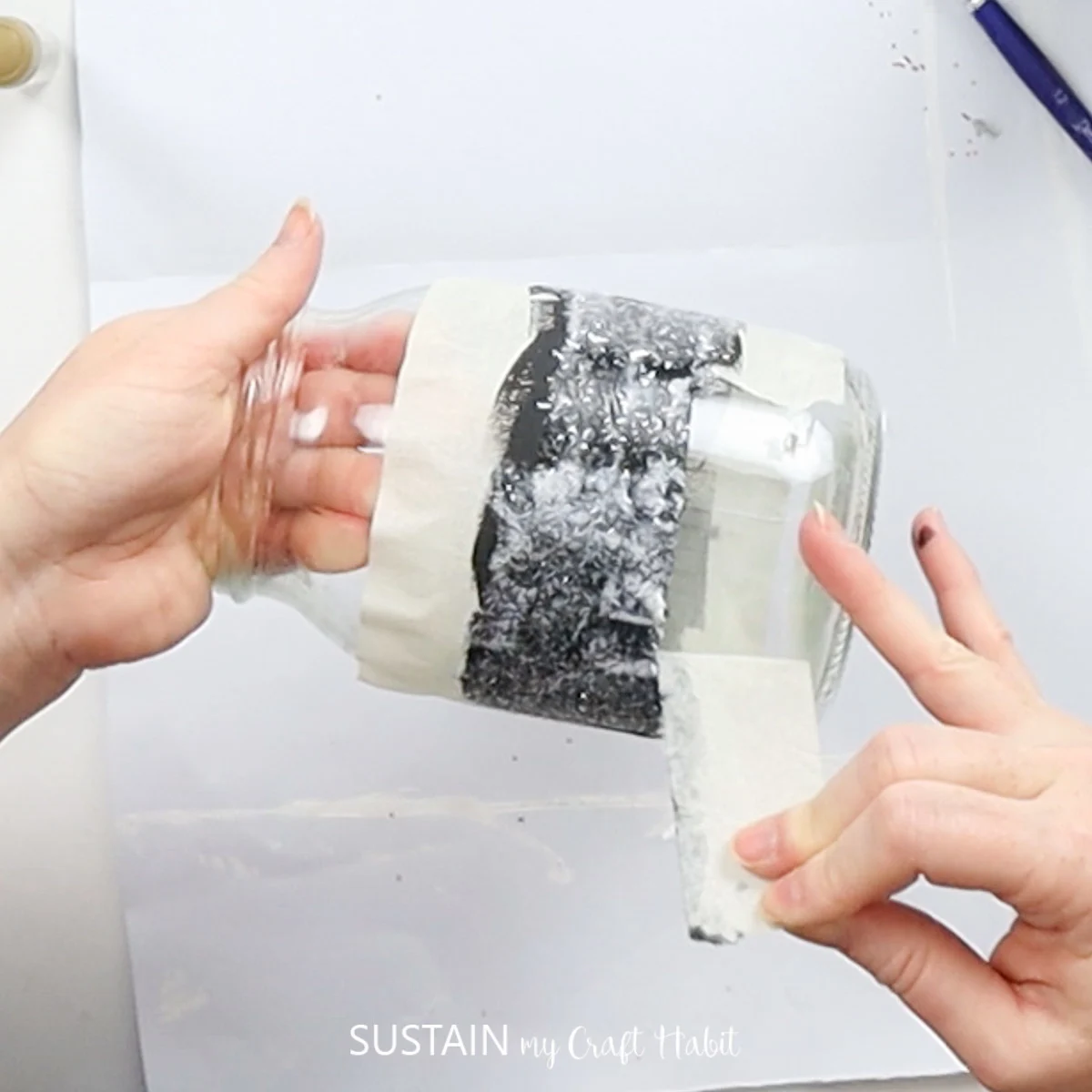 Removing tape from a jar.