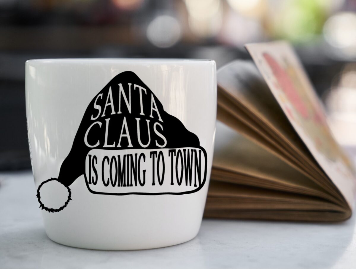 Coffee mug with a Santa Claus hat image on the front.