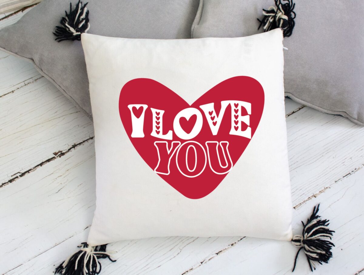 "I love you" heart printed on a pillow.