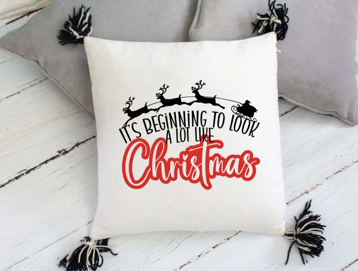 Pillow decorated with a Santa image and "it's beginning to look a lot like Christmas" wording.