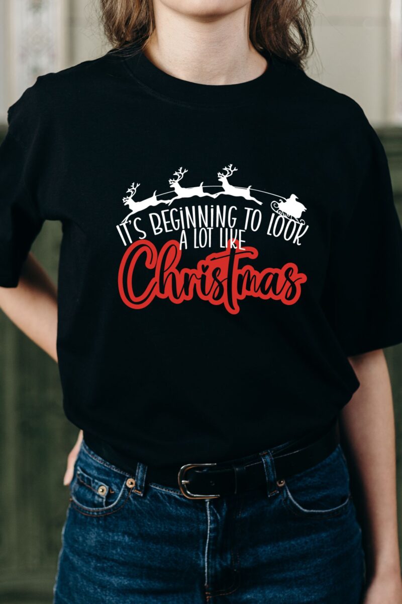 Black tshirt with a reindeer and Santa image and "it's beginning to look a lot like Christmas" wording.