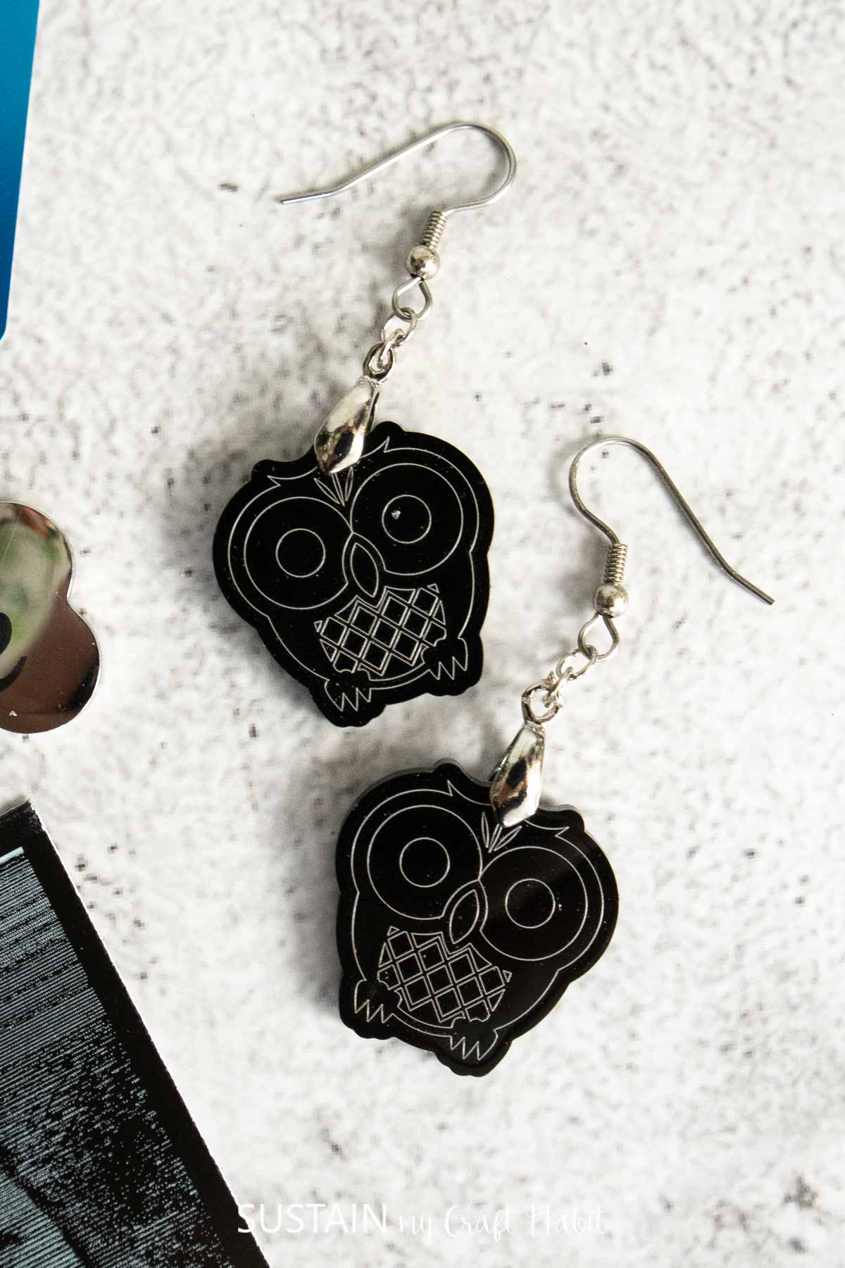 Engraved acrylic owl earrings.
