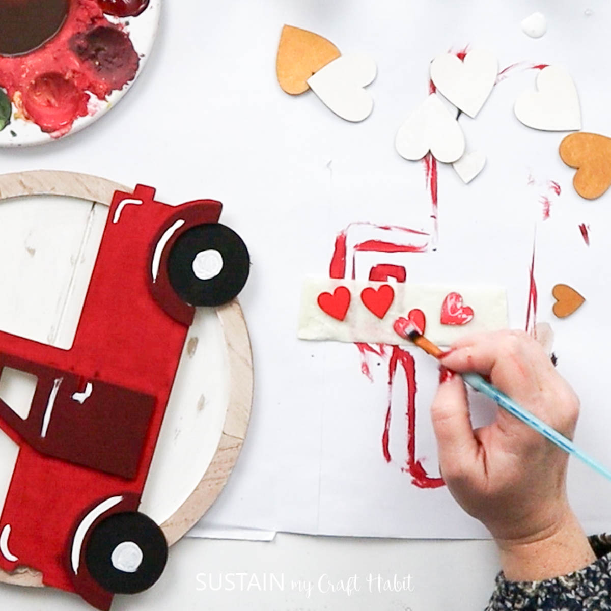 Painting wooden hearts.