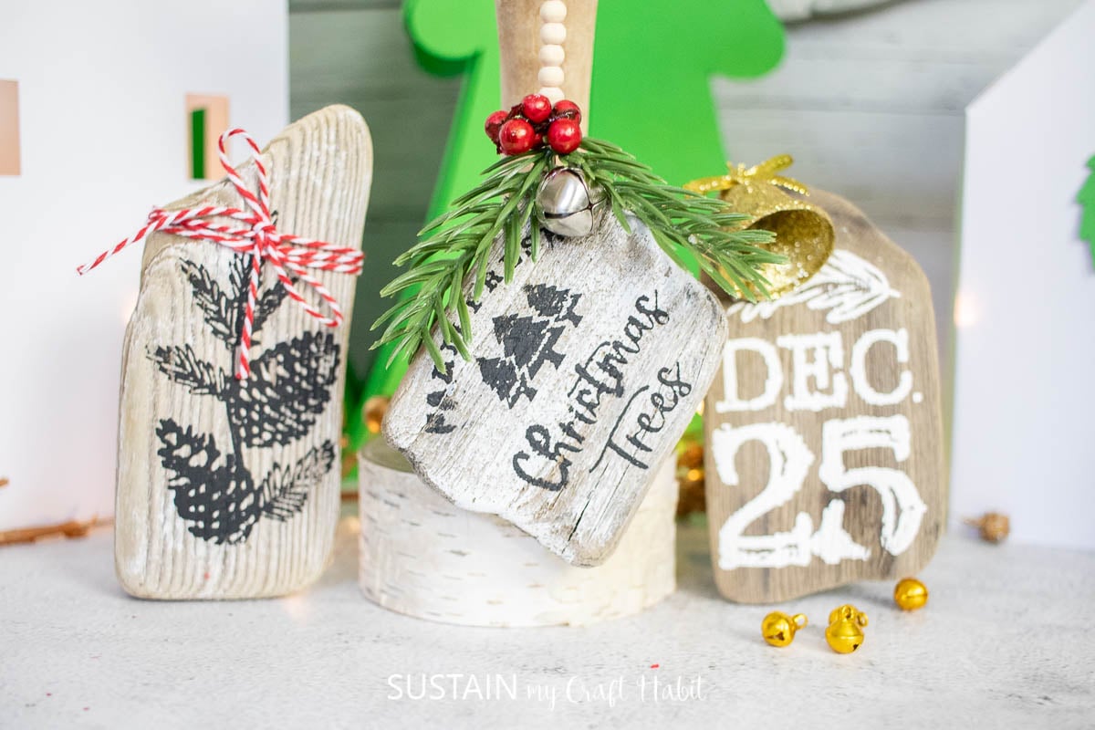 Driftwood ornaments decorated with chalk couture paint and embellishments.