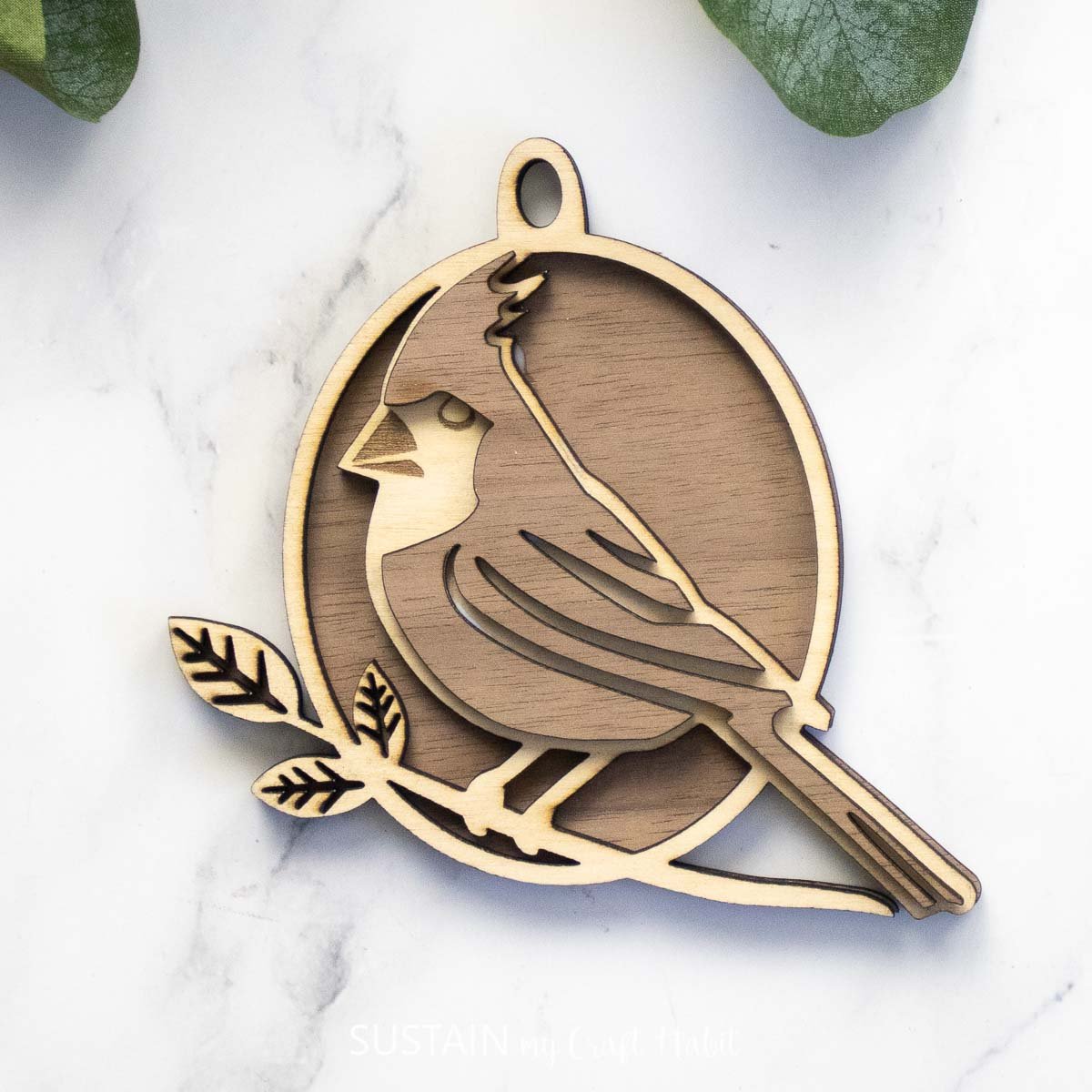 Two-toned wood layered cardinal ornament.