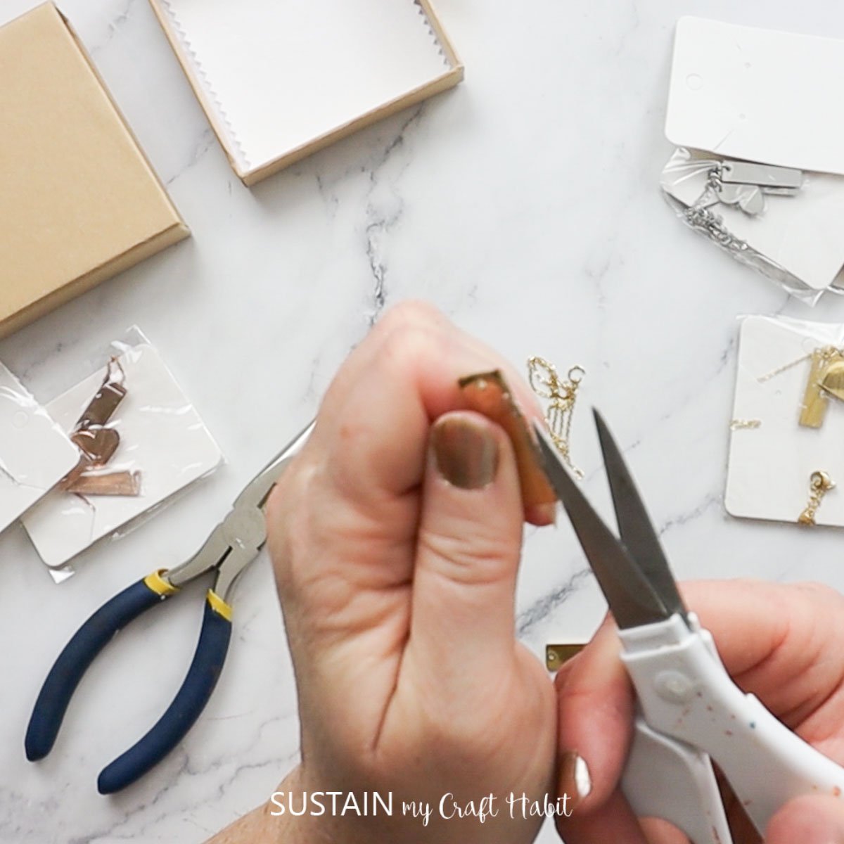 Removing plastic covering from pendant necklace.