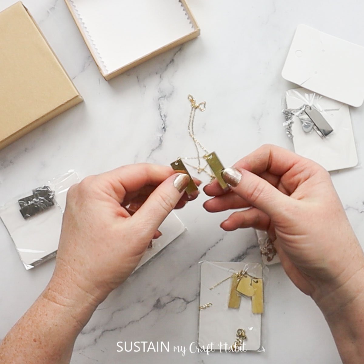 Removing pendant necklaces from packaging.