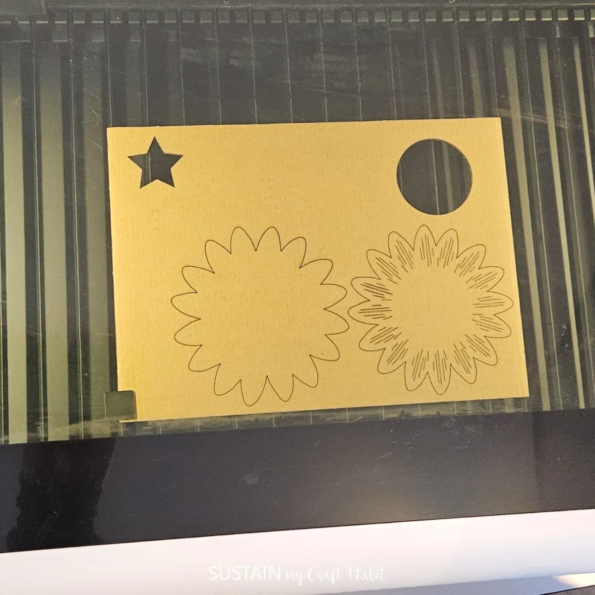 Removing laser cut shapes from the cardboard.