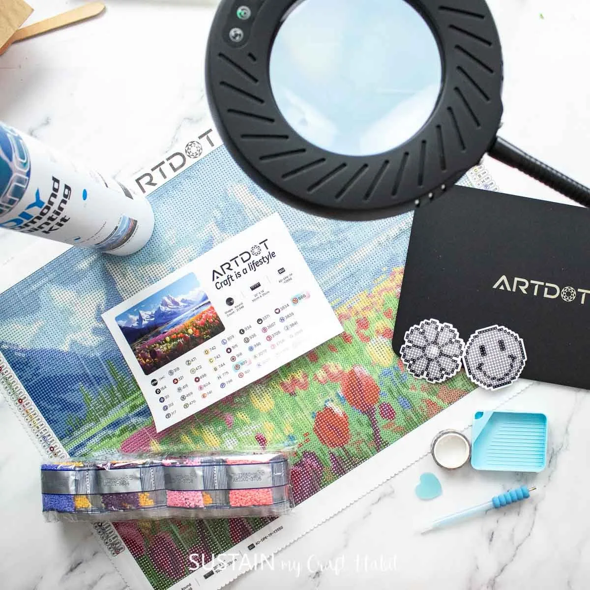 Various supplies from ARTDOT including a diamong painting kit and magnifying glass with stand.