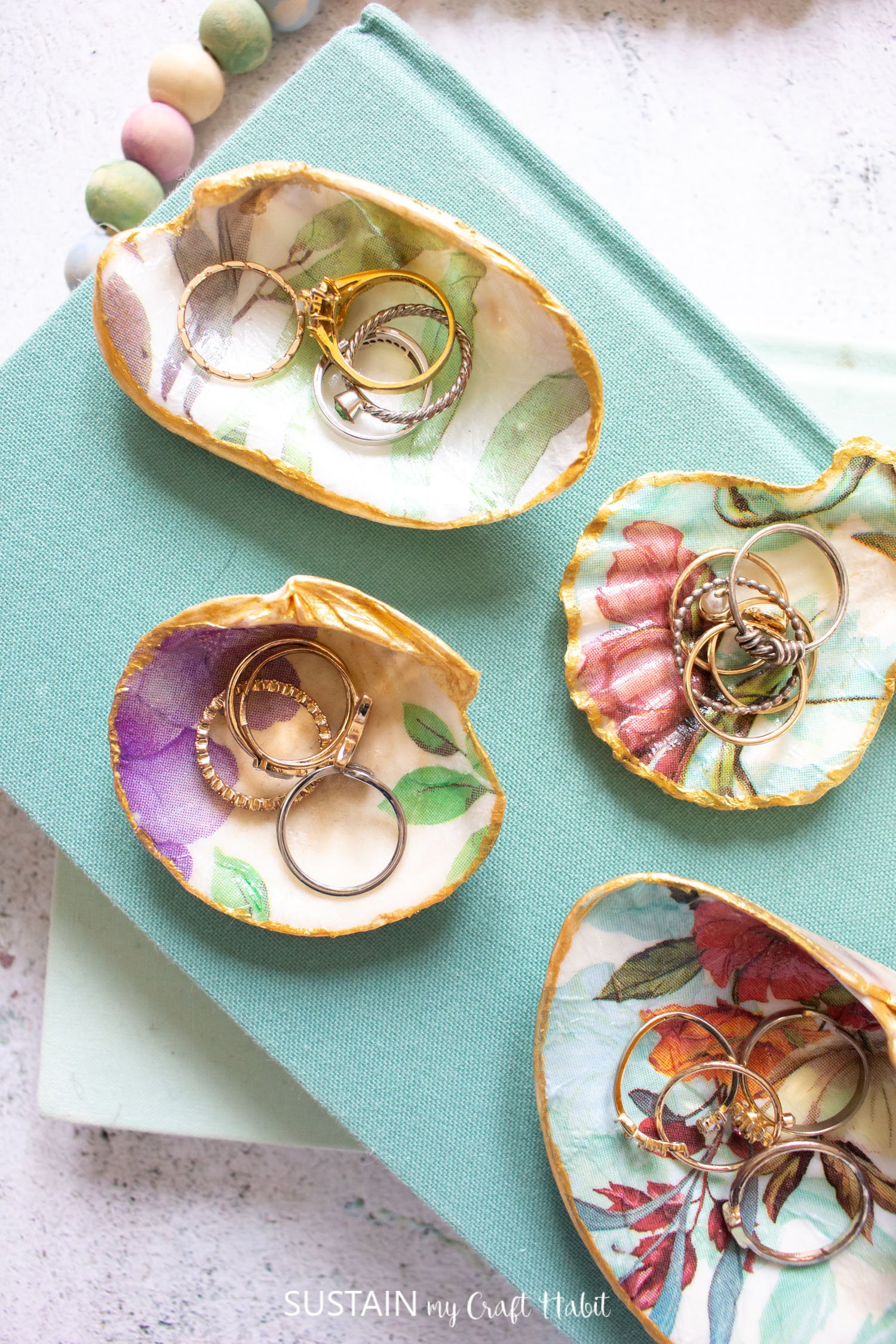 Trinket dishes made with seashells and Mod Podge holding jewellery.