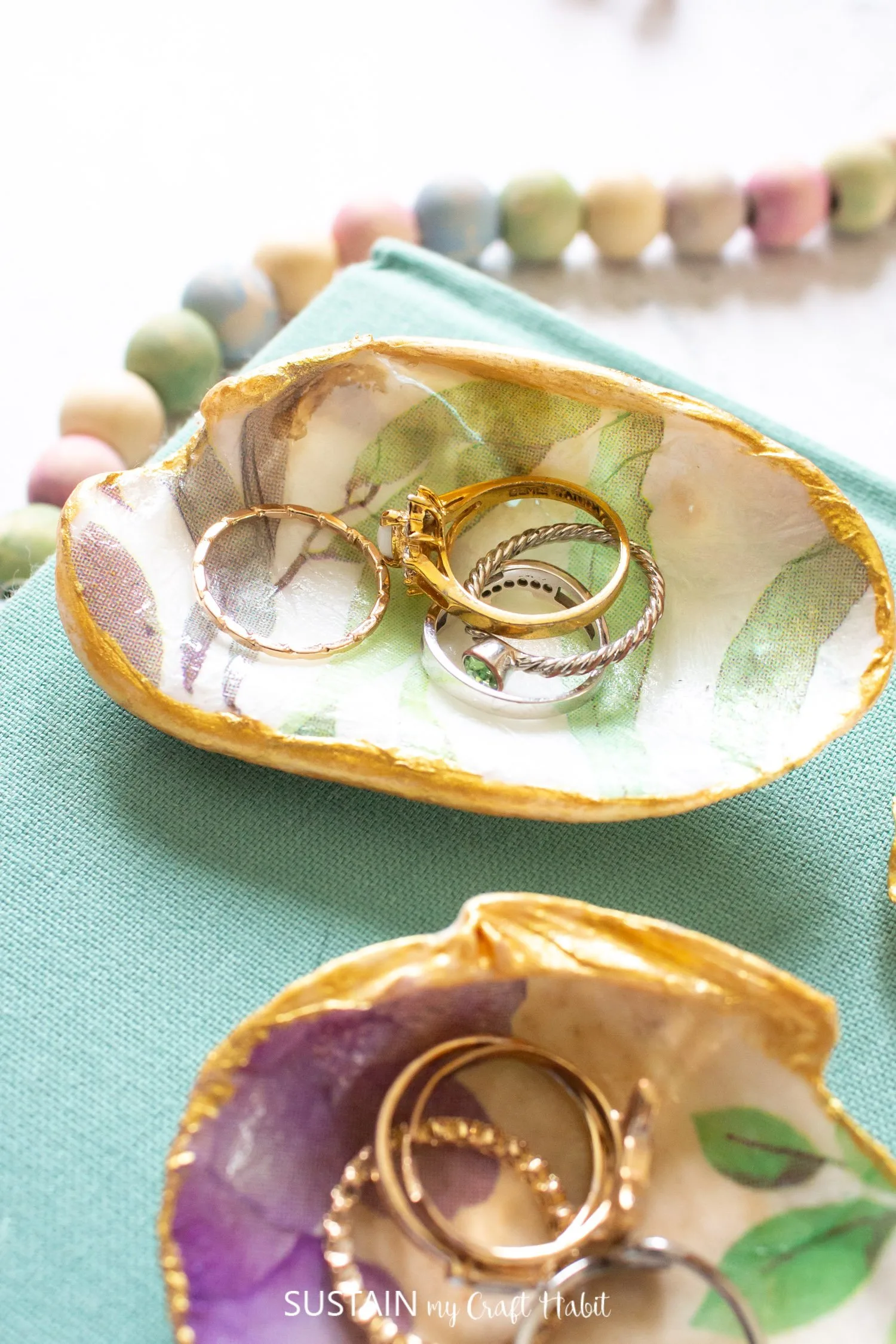 Trinket dishes made with seashells and Mod Podge holding jewellery.