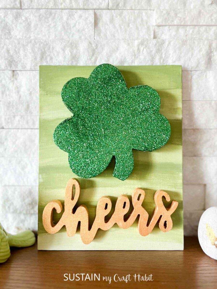 Saint Patrick's day sign with painted sign, shamrock and cheers sign.