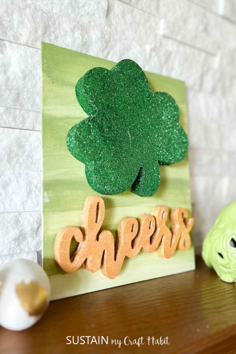 Saint Patrick's day sign with painted sign, shamrock and cheers sign.