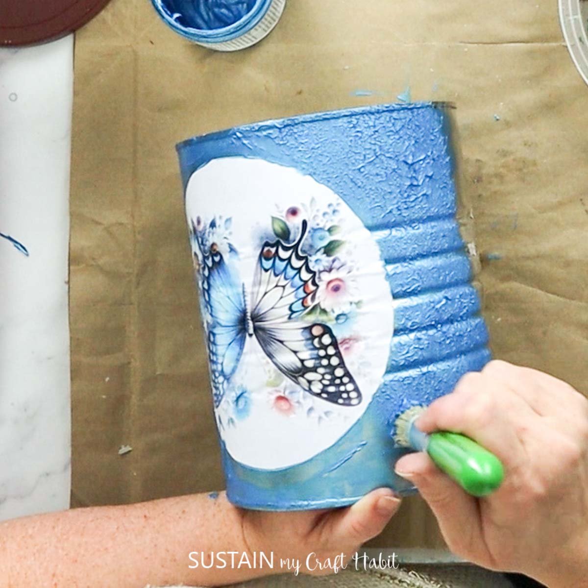 Using a stencil brush with blue paint.