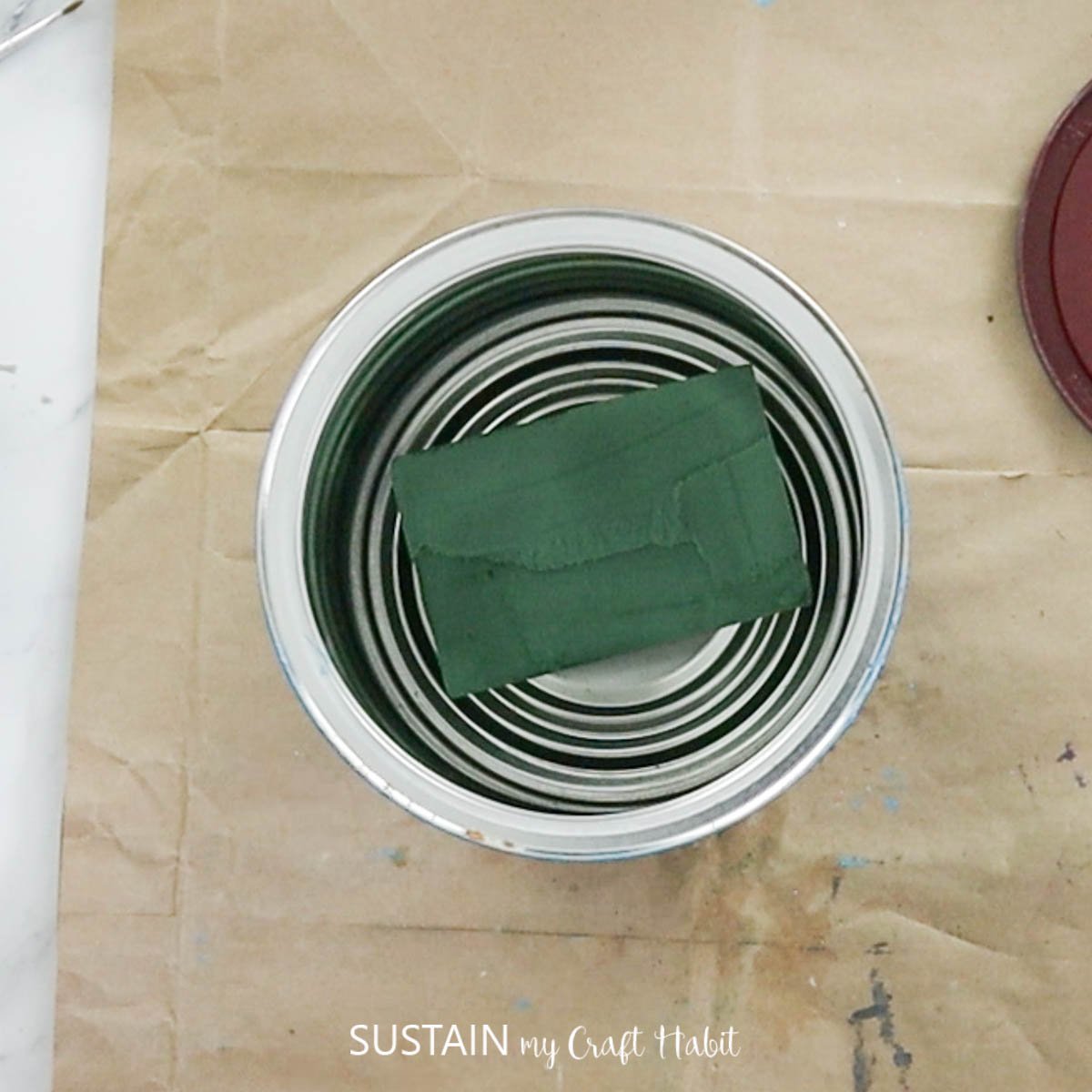 Floral foam in a tin can.