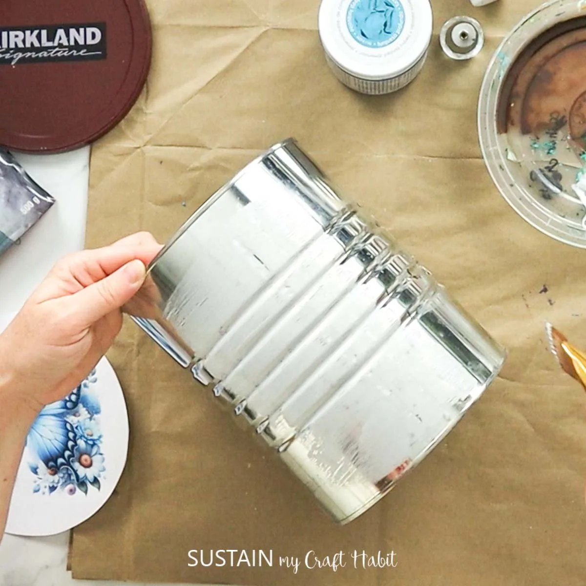 Adding glue to a tin can.