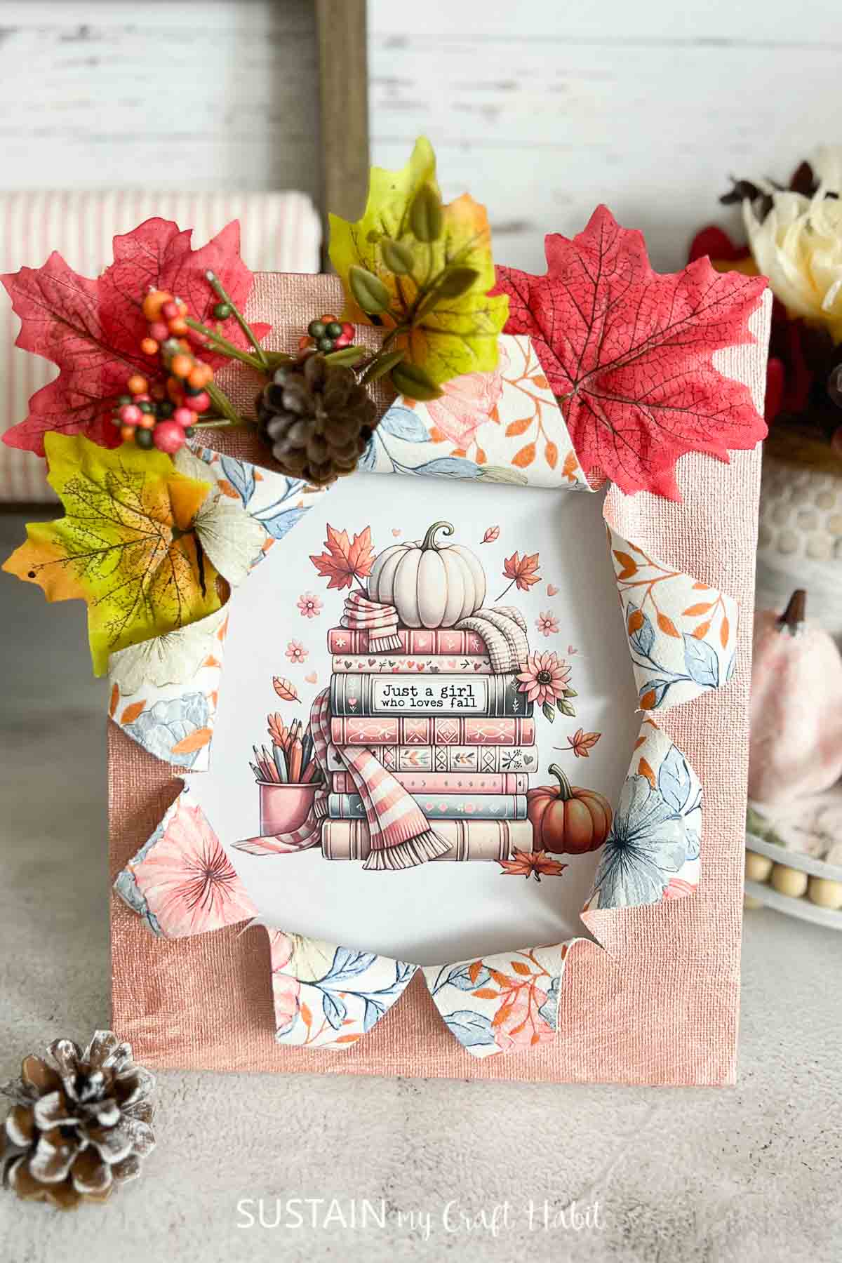 Busted canvas craft decorated for fall with embellishments and a fall image.