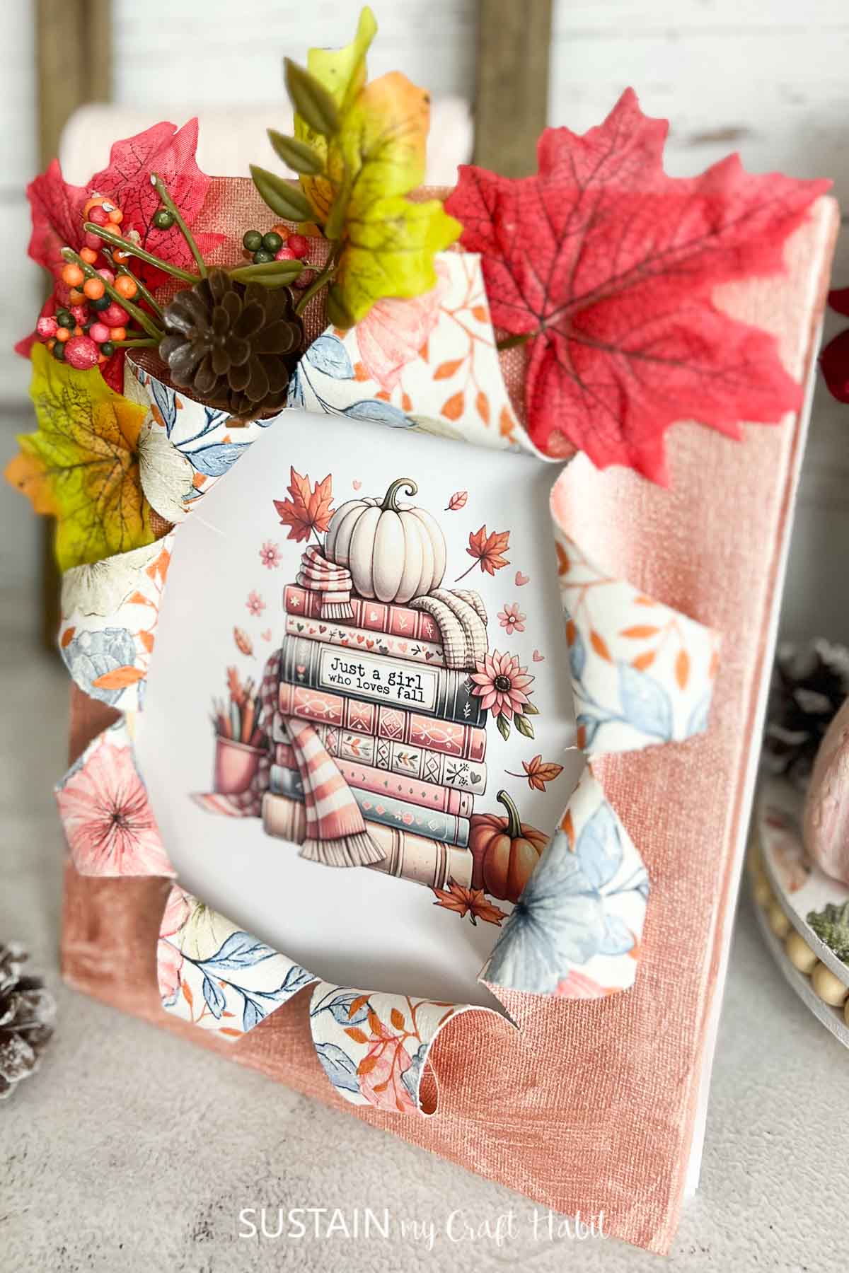 Busted canvas craft decorated for fall with embellishments and a fall image.